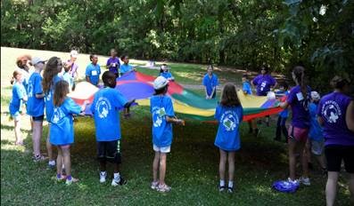 group of kids at grief camp with parachute