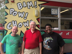 food truck with three men in front of it