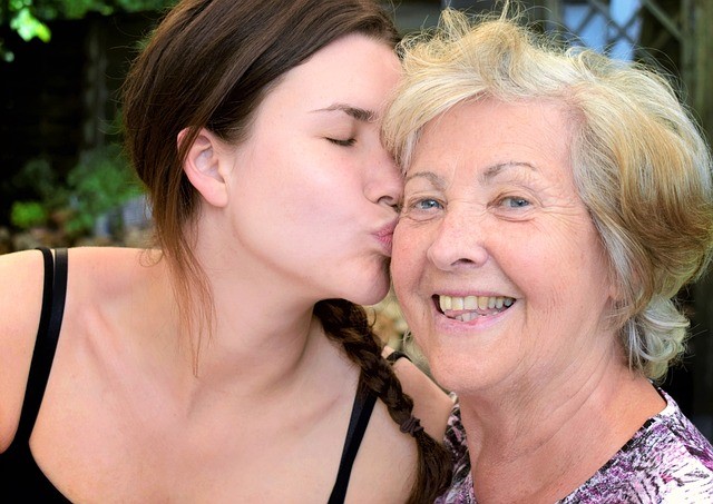 young woman kissing older woman on cheek