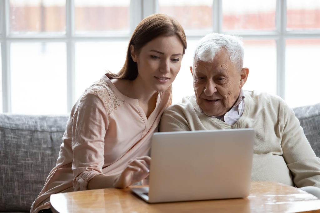 two adults looking at laptop